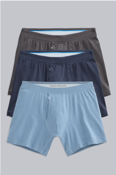 Three pairs of men's underwear in gray, navy, and blue on a light gray background.