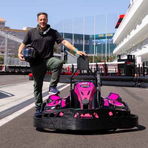 A man in a go-kart on a race track wearing  Maverick tech chino